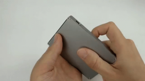 Person Holding Small Gray Object