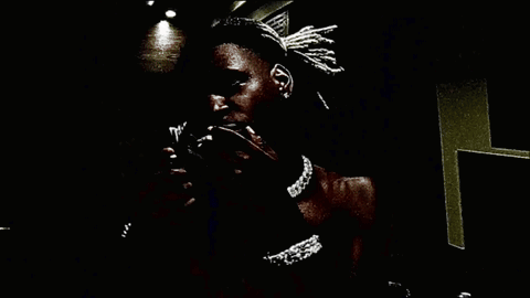 Person Holding Stack of Money in Dark Room