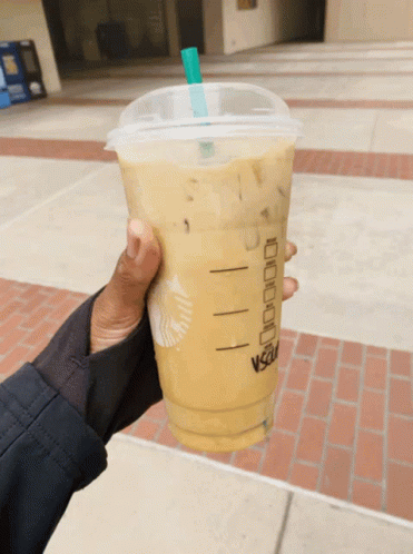 Person Holding Starbucks Drink With Straw