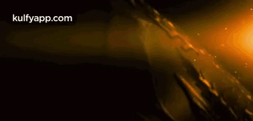 Person Holding Sword in Dark Room