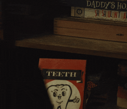 Person Holding Teeth Book With Tooth GIF