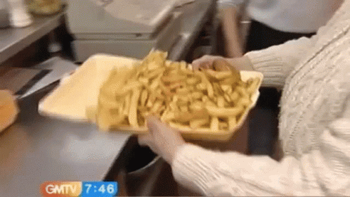 Person Holding Tray Of Fries By GMTV Sign GIF