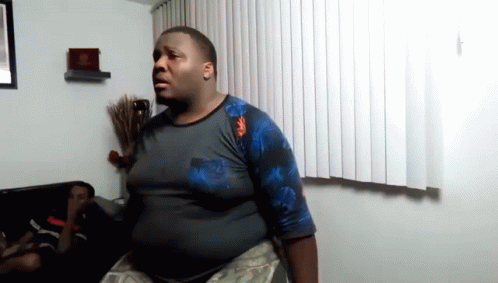 Person Holding Two Boxes Of King's Bridges And Raptor Rush GIF