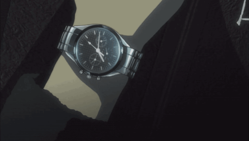 Person Holding Watch at Almost 5:00