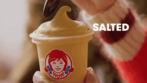 Person Holding Wendy's Ice Cream With Spoon