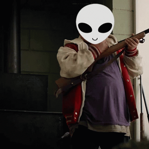 Person In Alien Mask Holding Rifle GIF