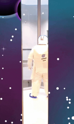 Person In Astronaut Suit Getting Off Elevator GIF