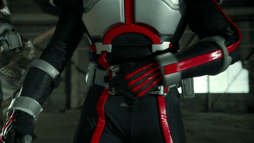 Person in Black and Red Costume with 00000 Belt
