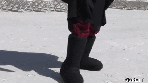 Person In Black Boots And Red Shorts Standing In Snow GIF