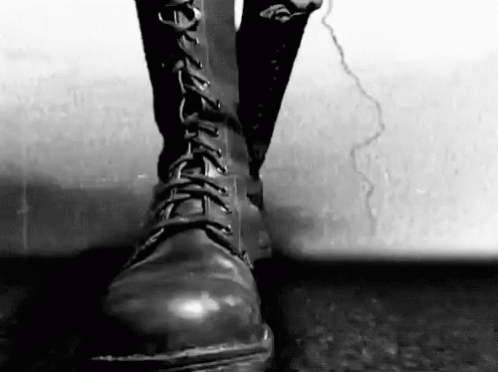Person In Black Boots On Cracked Sidewalk GIF