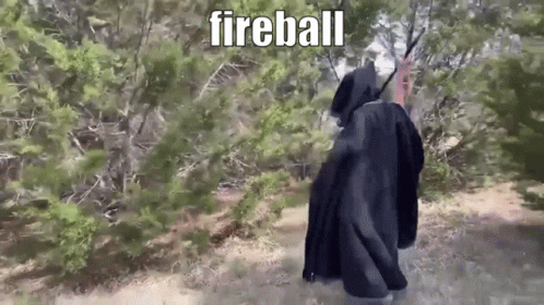 Person in Black Cloak Walking Forest Fireball