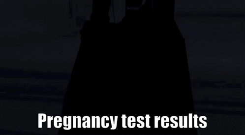 Person in Black Dress in Front of Pregnancy Test Results Sign