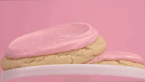 Person in Black Gloves Frosting Cookie