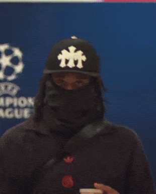 Person in Black Hat With Letter T