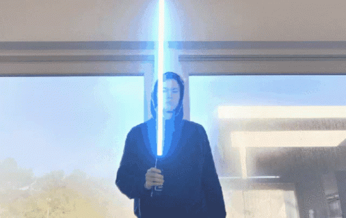 Person in Black Hoodie Holding Blue Lightsaber
