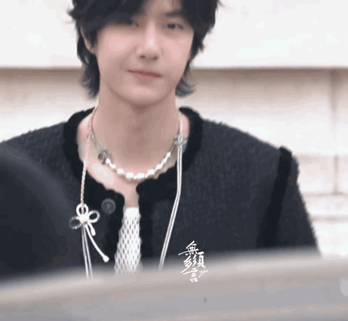 Person In Black Jacket And Pearl Necklace GIF