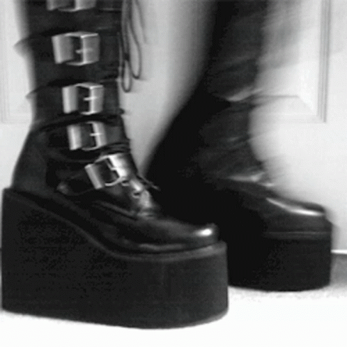 Person in Black Platform Boots With Buckles