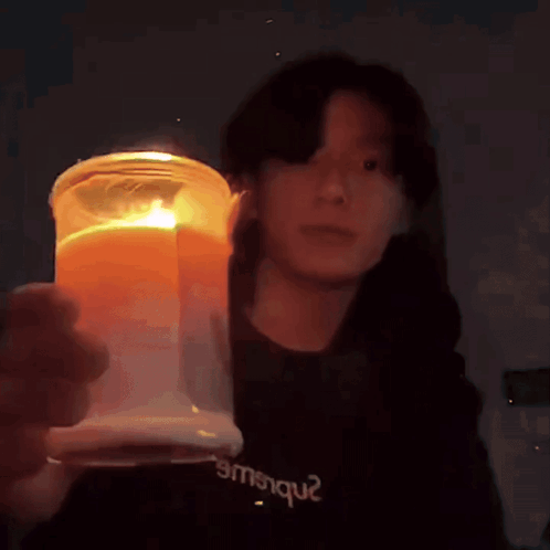 Person in Black Shirt Emsique Holding Candle