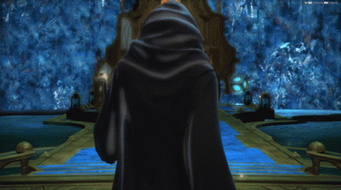 Person In Blue Cloak In Front Of Building GIF