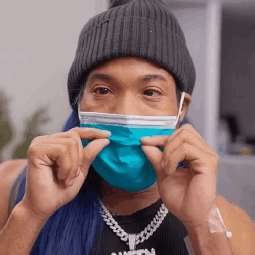 Person in Blue Face Mask and Black Tank Top