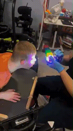 Person in Blue Gloves Holding Cube