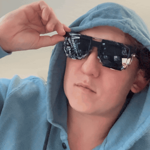 Person In Blue Hoodie And Sunglasses Taking Picture GIF