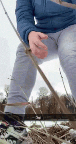Person in Blue Jacket and Grey Pants Holding Fishing Rod DNI
