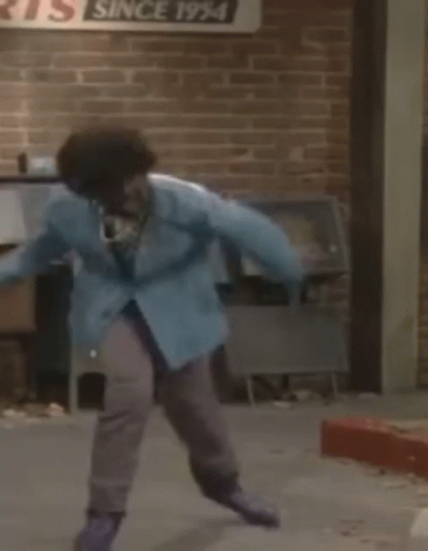 Person in Blue Jacket Jumping Near Mailbox