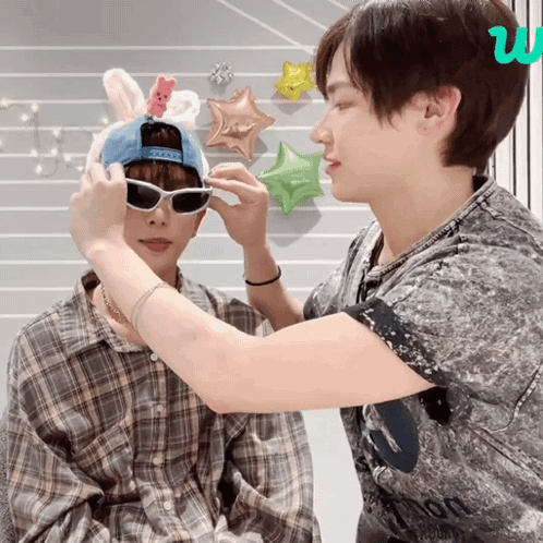Person in Bunny Hat and Sunglasses Being Helped