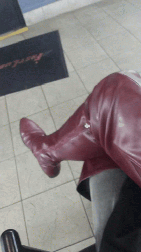 Person In Burgundy Boots Sitting On Chair Before Fast Lane Doormat GIF