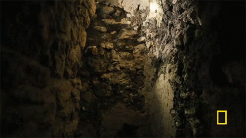 Person in Cave With National Geographic Logo