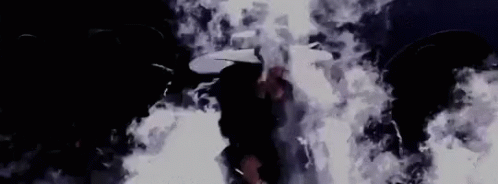Person in Dark Room With Smoke From Ceiling