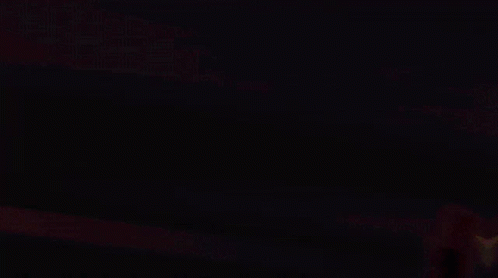 Person in Dark Room with Yellow Arrows