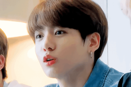 Person in Denim Shirt and Earrings Close Up