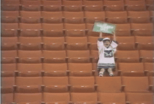 Person in Empty Stadium With H on Shirt