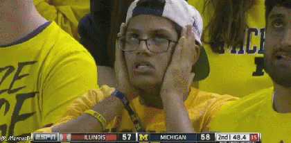 Person in Glasses and Cap Watching Michigan vs Illinois