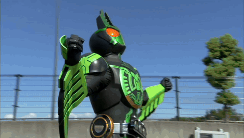 Person In Green And Black Costume With Letter E GIF