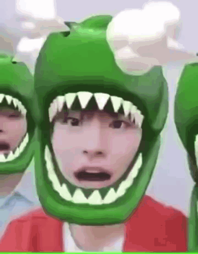 Person in Green Helmet With Sharp Teeth