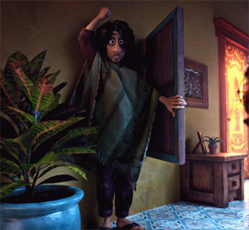 Person in Green Poncho Standing in Front of Door