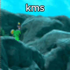 Person in Green Shirt Standing on Rock