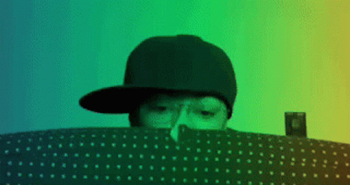 Person In Hat Looking Over Polka Dot Blanket GIF