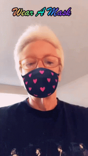 Person in Heart Mask Saying Wear a Mask