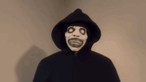 Person in Hooded Cape with Skeleton Face