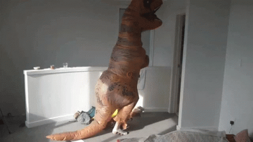 Person In Inflatable T-Rex Costume GIF