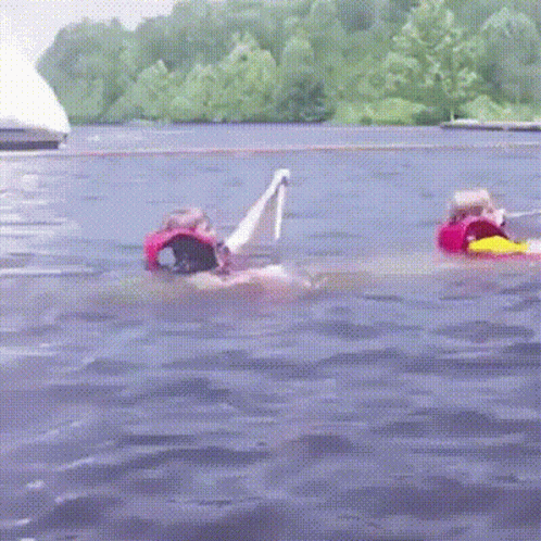 Person In Life Vest Floating On Raft GIF