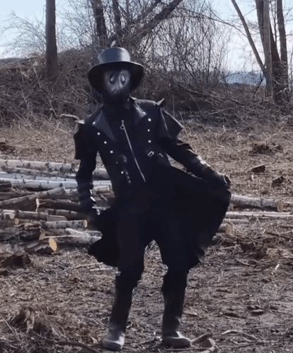 Person in Mask and Hat in Log Field