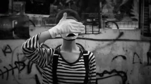 Person in Mime Mask Covering Eyes