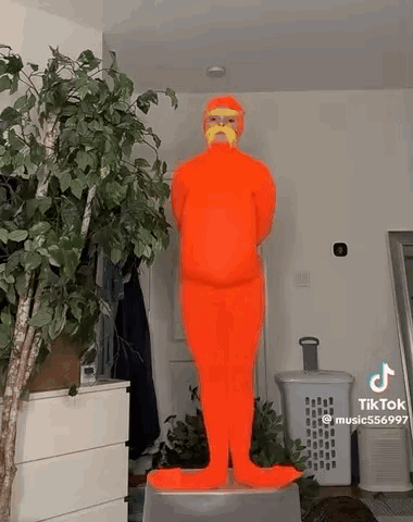 Person in Orange Costume with Mustache on Stool