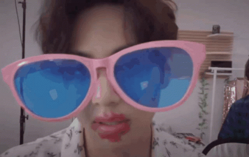 Person In Pink And Blue Sunglasses With Red Lipstick GIF