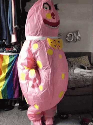 Person In Pink Inflatable Costume In Bedroom GIF
